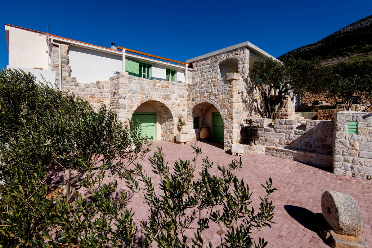 stone house with olive trees